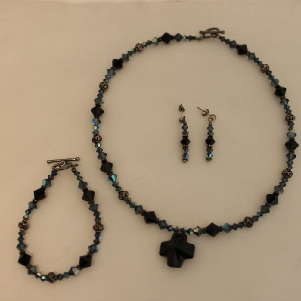 Matching earrings, bracelet and necklace, blue and black and dark metal